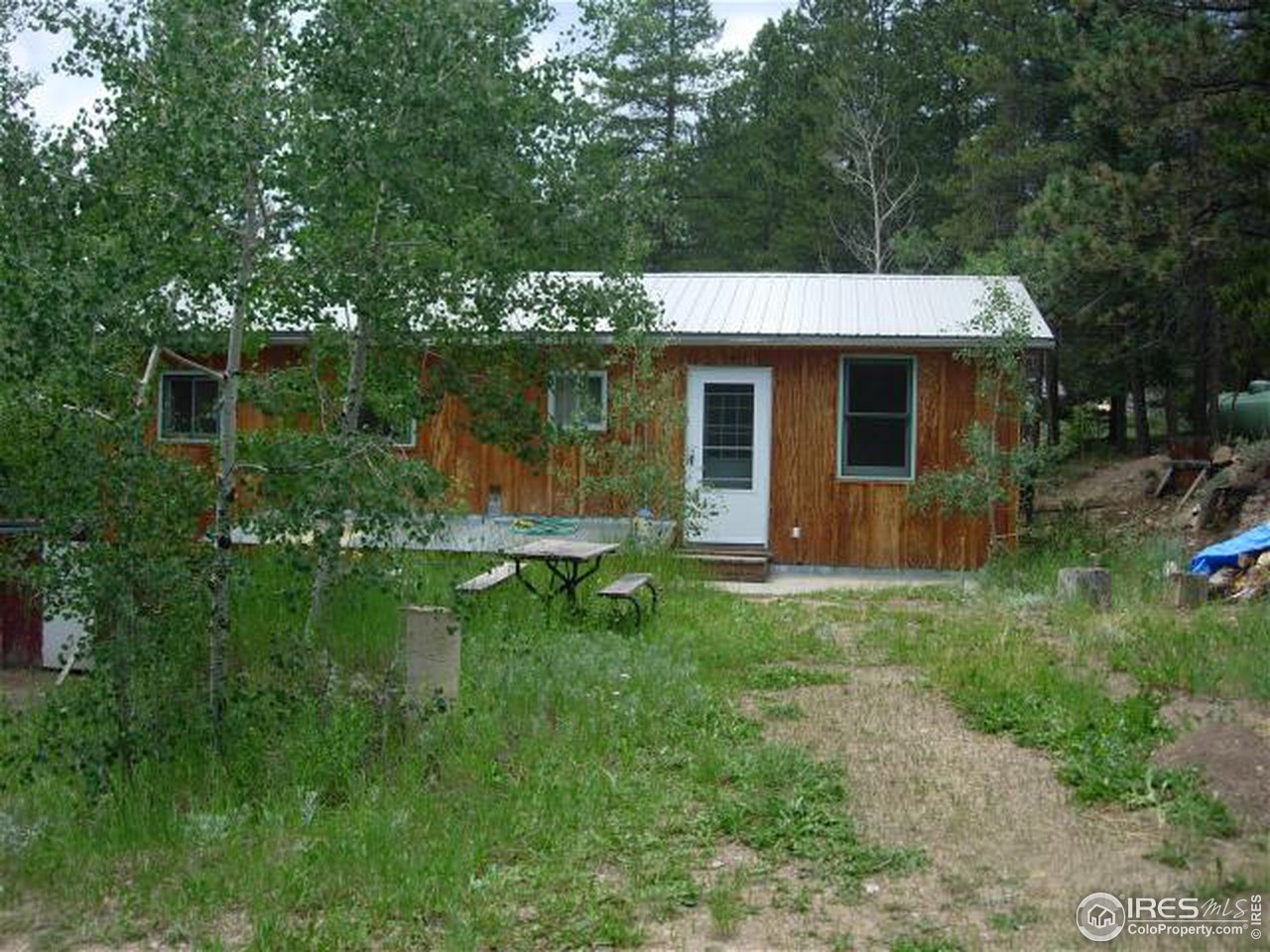 1654 Ridge Road Nederland, CO 80466 - Photo 1 of 18 a view of a house with backyard sitting area and garden
