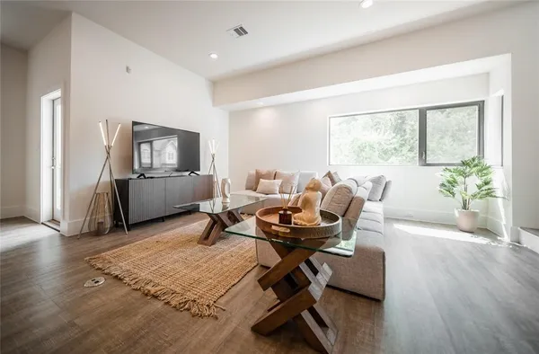 a living room with furniture rug and a window