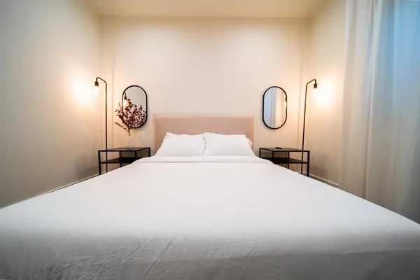 a bedroom with a bed and a wall painting