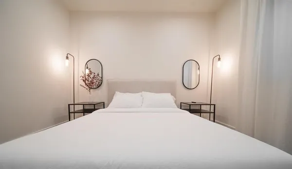 a bedroom with a bed and a lamp on it