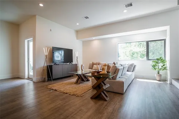 a living room with furniture window and wooden floor