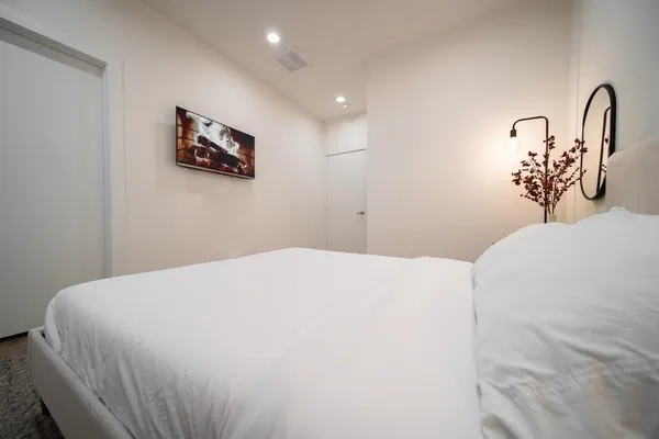 a bedroom with a bed and a wall painting
