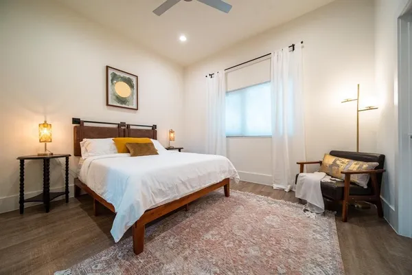 a bedroom with a bed and a chair
