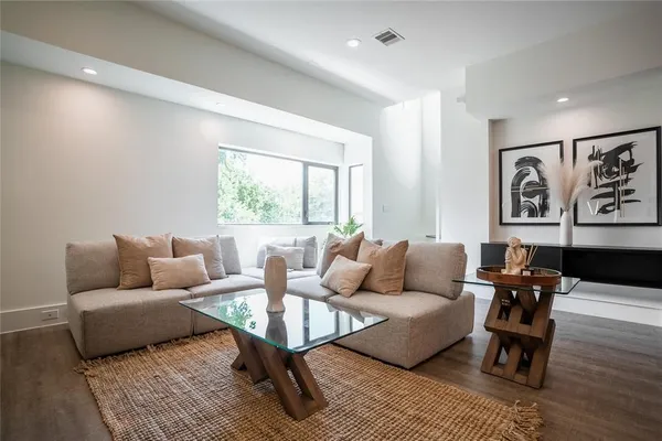 a living room with furniture and wooden floor