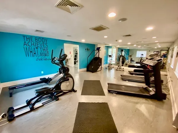 a room with gym equipment and a view of living room