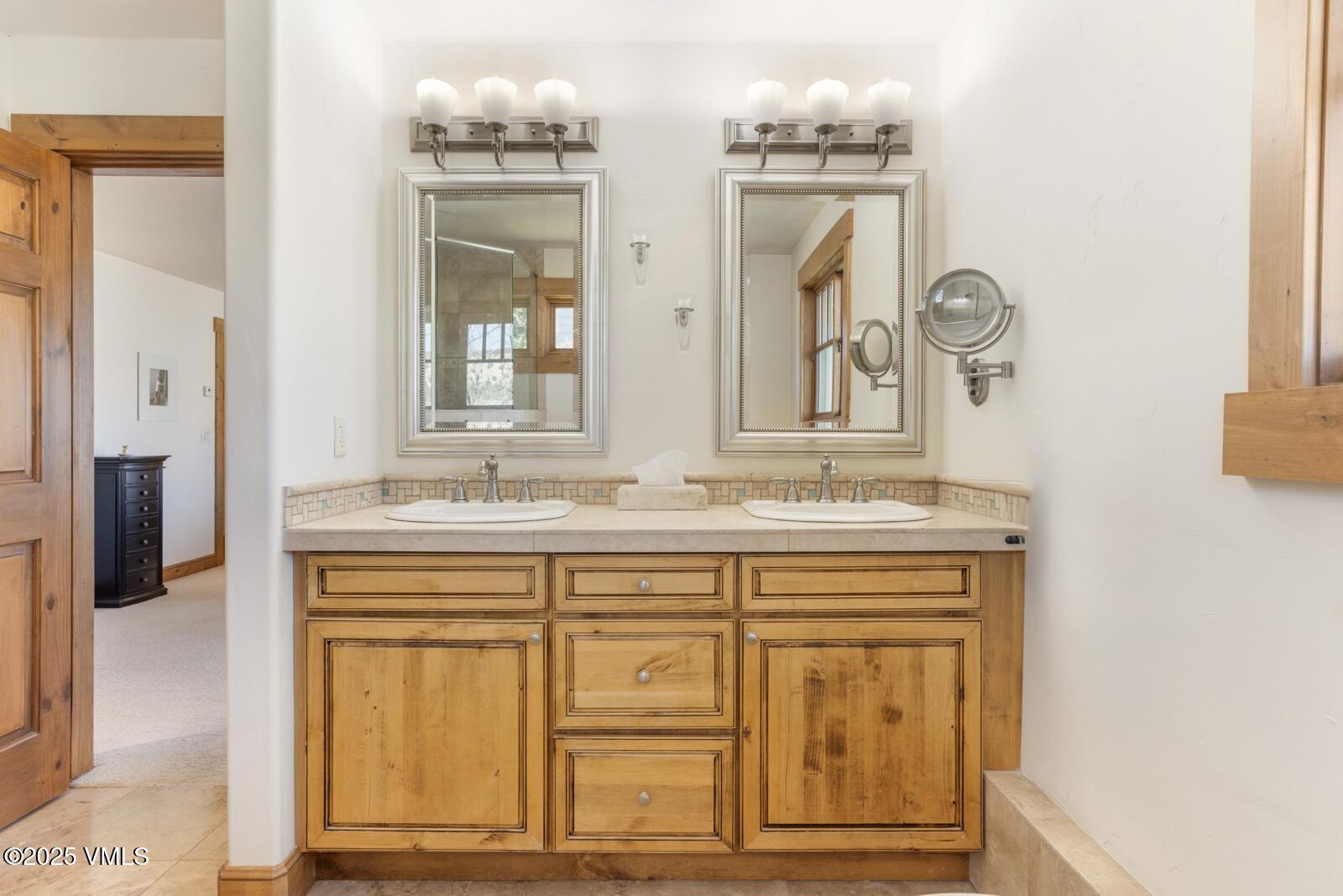 25 Sunset Court Eagle, CO 81631 - Photo 13 of 47 a bathroom with a granite countertop sink a large mirror and a window