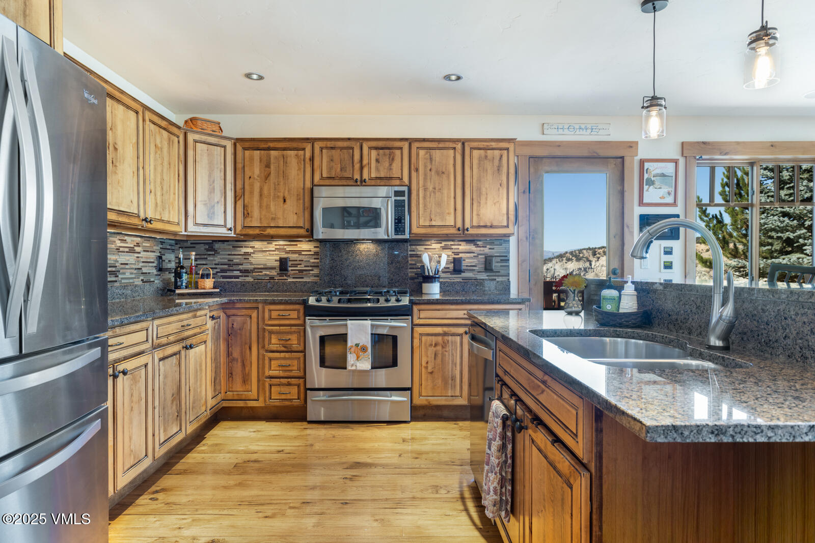 25 Sunset Court Eagle, CO 81631 - Photo 7 of 47 a kitchen with stainless steel appliances granite countertop a sink stove microwave and refrigerator