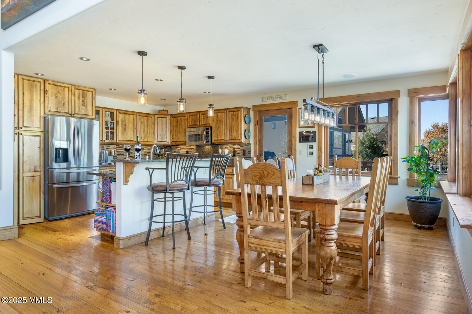 25 Sunset Court Eagle, CO 81631 - Photo 9 of 47 a view of a dining room and livingroom with furniture wooden floor a chandelier
