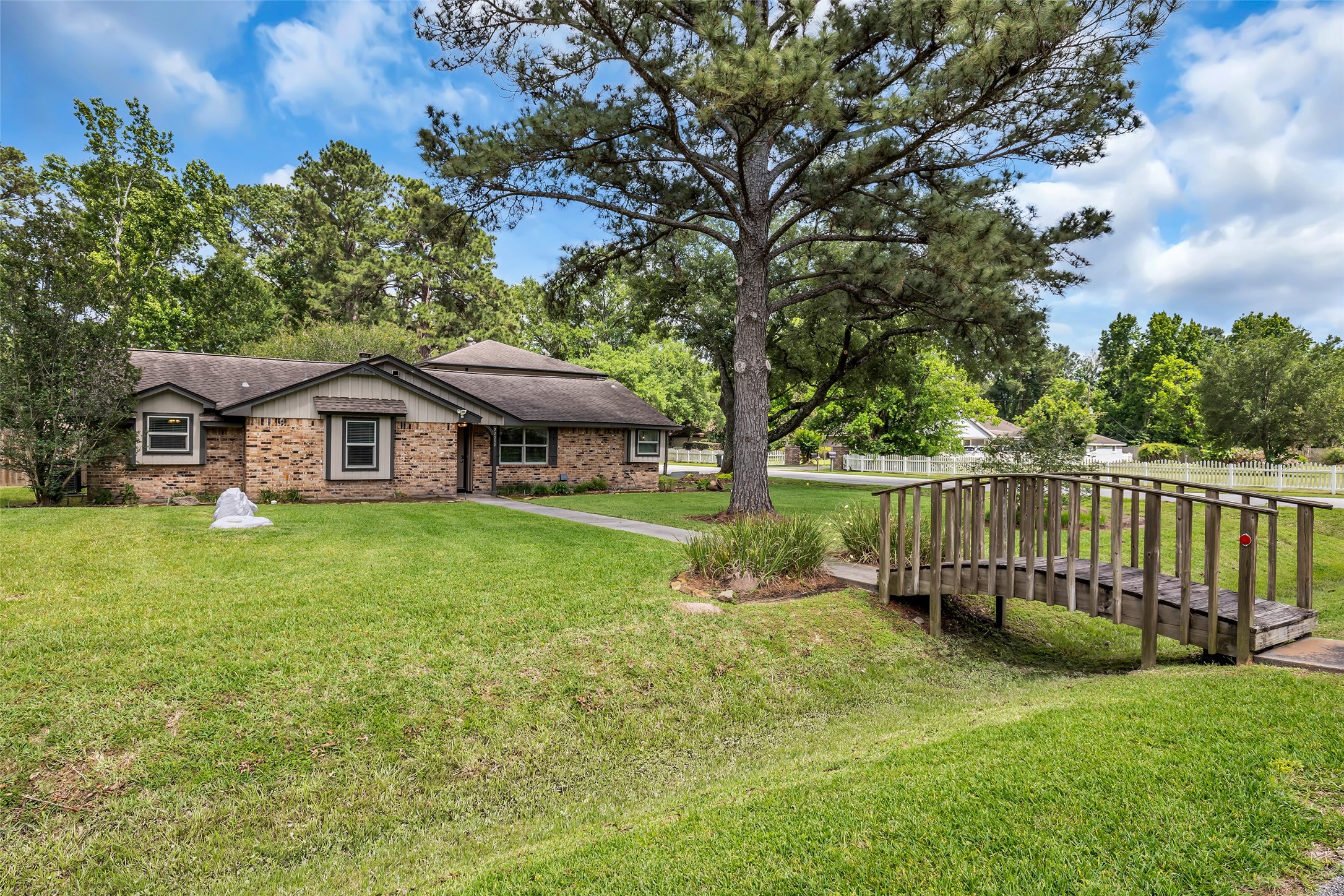 22502 Fields Lane Spring, TX 77389 - Photo 2 of 39 The property is surrounded by lush greenery, offering a serene and inviting atmosphere.