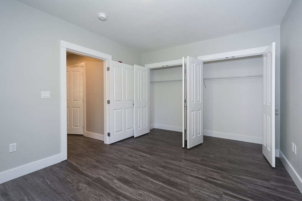 50 Country Way, Unit C204 Scituate, MA 02066 - Photo 15 of 22 an empty room with wooden floor & closet area