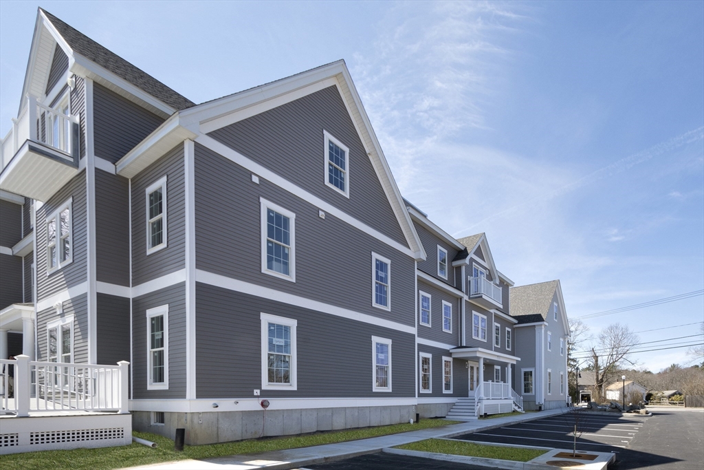 50 Country Way, Unit C204 Scituate, MA 02066 - Photo 17 of 22 a front view of a building with garden