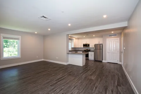 a view of kitchen with sink and wooden floor