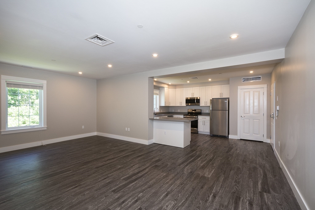 50 Country Way, Unit C204 Scituate, MA 02066 - Photo 5 of 22 a view of kitchen with sink and wooden floor