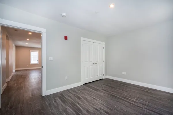 a view of a room with wooden floor and windows