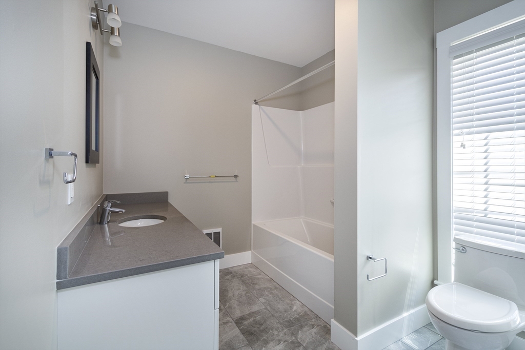 50 Country Way, Unit C204 Scituate, MA 02066 - Photo 8 of 22 a bathroom with a sink a toilet and shower