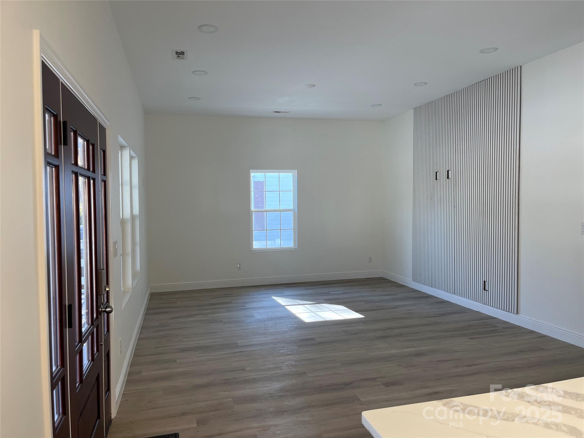 417 Boyte Street Monroe, NC 28110 - Photo 13 of 25 an empty room with wooden floor and a window