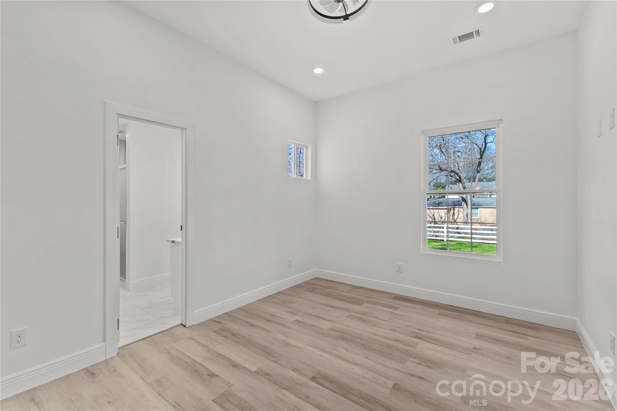 417 Boyte Street Monroe, NC 28110 - Photo 15 of 42 an empty room with wooden floor and windows