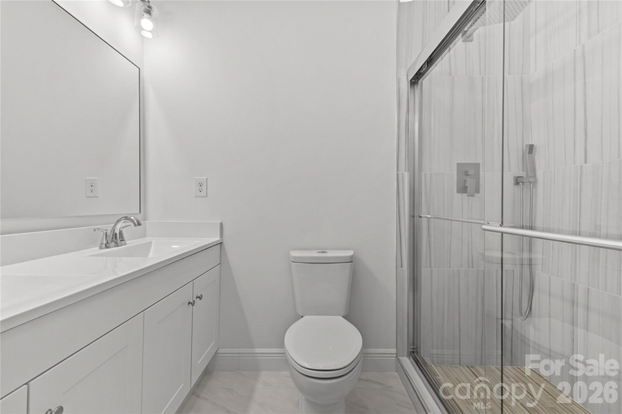 417 Boyte Street Monroe, NC 28110 - Photo 29 of 42 a bathroom with a toilet a sink and mirror