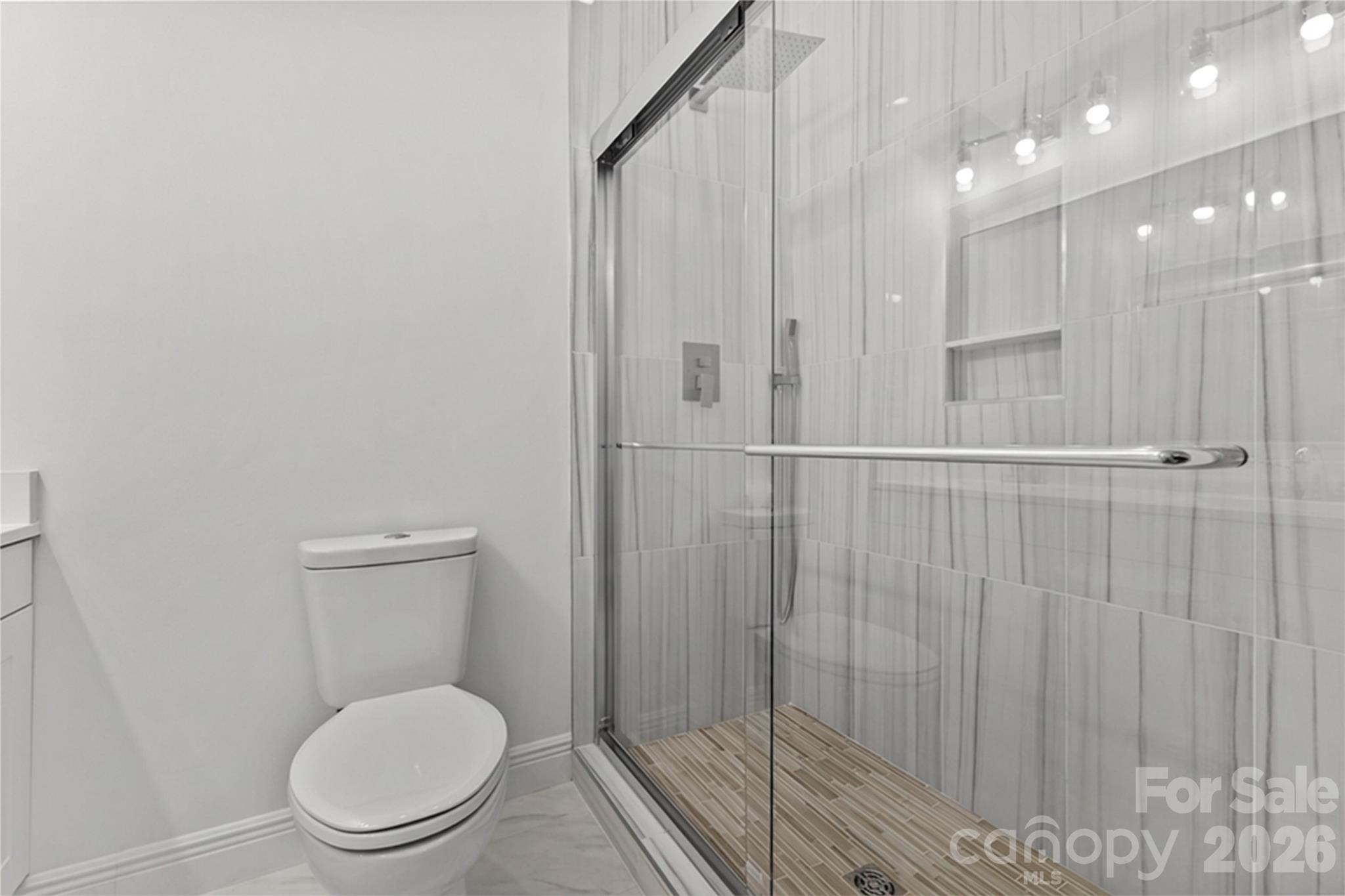 417 Boyte Street Monroe, NC 28110 - Photo 30 of 42 a bathroom with a toilet a sink and shower