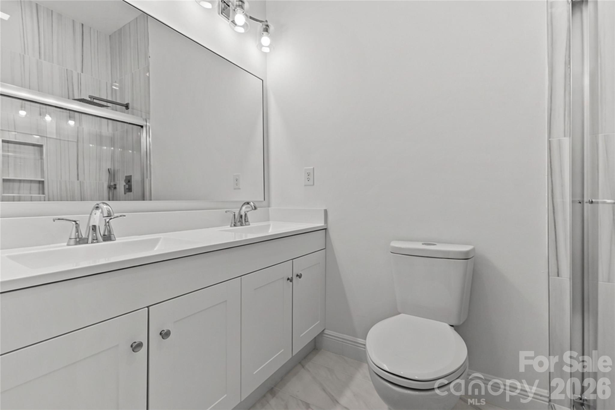 417 Boyte Street Monroe, NC 28110 - Photo 31 of 42 a bathroom with a toilet a sink and mirror