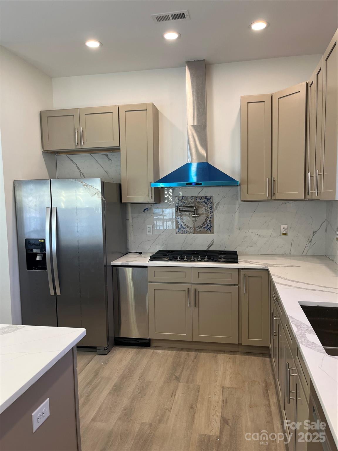 417 Boyte Street Monroe, NC 28110 - Photo 9 of 25 a kitchen with stainless steel appliances granite countertop a stove a sink and a refrigerator