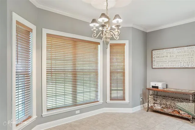 a view of a room with a window and furniture