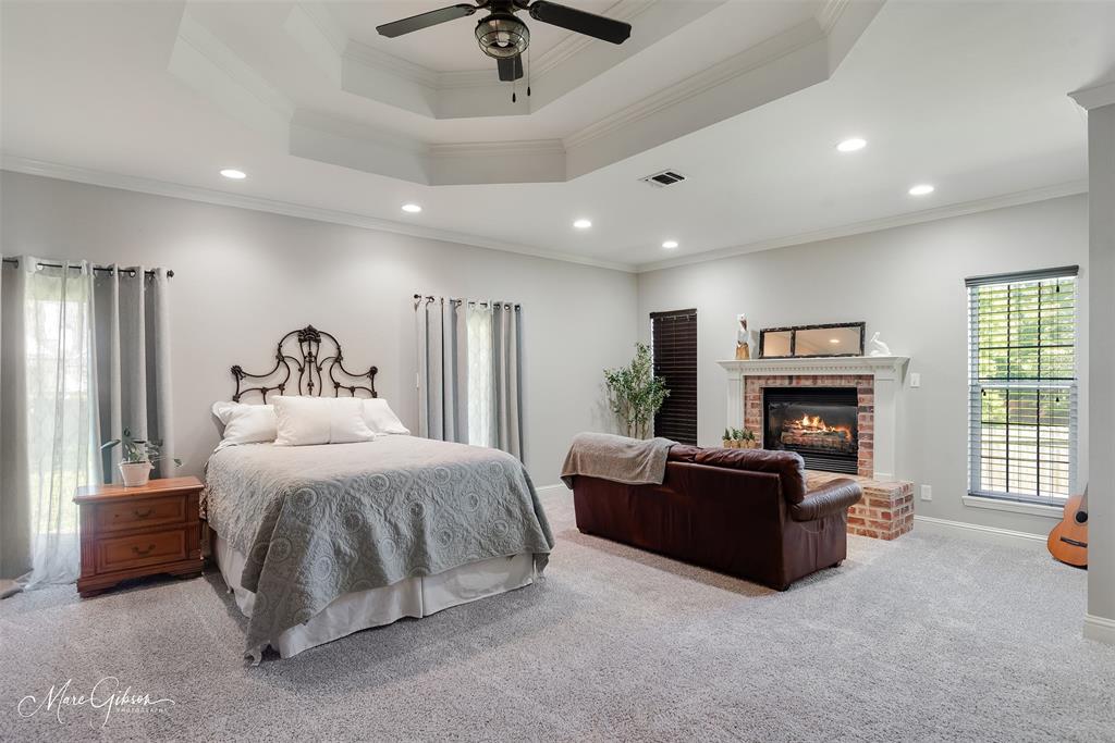 2228 Grapevine Lane Haughton, LA 71037 - Photo 14 of 25 a spacious bedroom with a bed and a fireplace