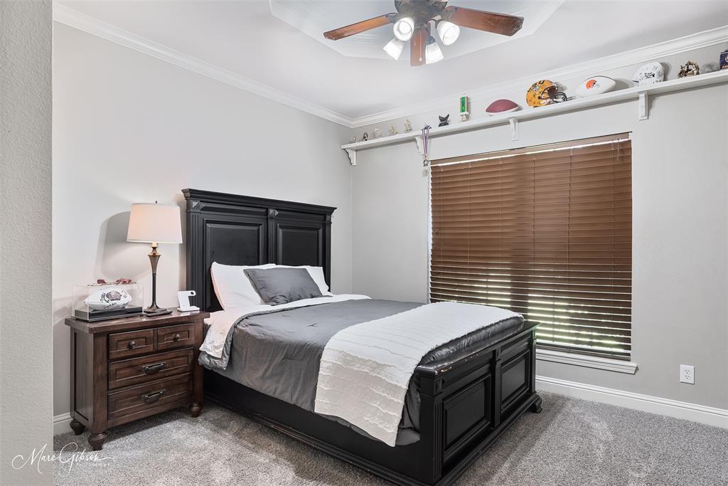 2228 Grapevine Lane Haughton, LA 71037 - Photo 17 of 25 a bedroom with a bed and a chandelier