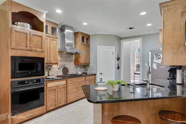 a kitchen with stainless steel appliances granite countertop a sink stove and cabinets
