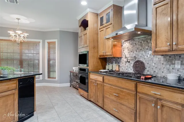 a kitchen with stainless steel appliances granite countertop a sink stove and cabinets