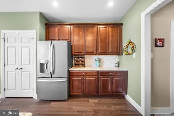 a kitchen with stainless steel appliances granite countertop a refrigerator and a stove top oven