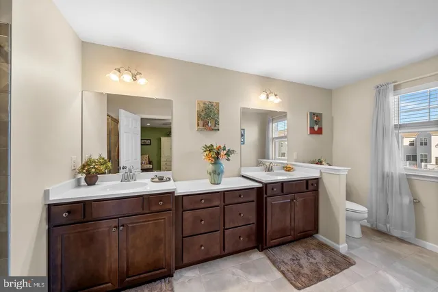 a spacious bathroom with a double vanity sink mirror and double