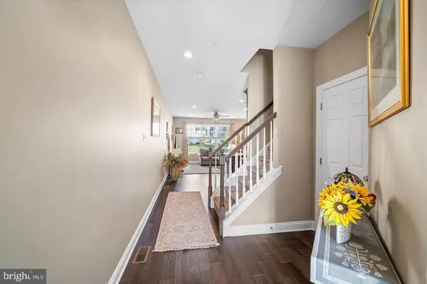 a view of entryway and hall with wooden floor