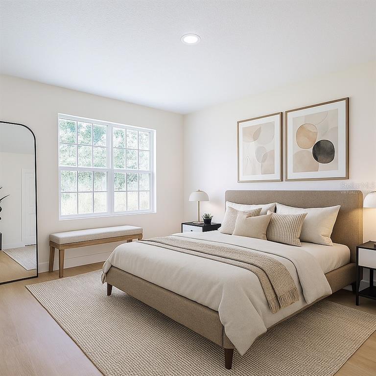 8724 Capilla Street Sebring, FL 33872 - Photo 12 of 33 a bedroom with a bed and a large window