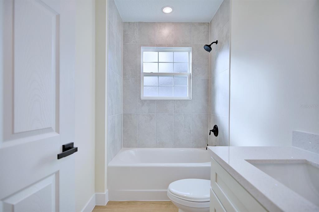 8724 Capilla Street Sebring, FL 33872 - Photo 19 of 33 a bathroom with a toilet a sink and bathtub