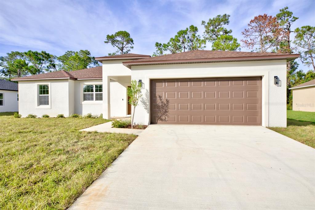 8724 Capilla Street Sebring, FL 33872 - Photo 2 of 33 front view of a house with a outdoor space
