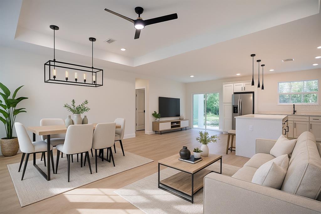 8724 Capilla Street Sebring, FL 33872 - Photo 4 of 33 a living room with furniture kitchen view and a chandelier