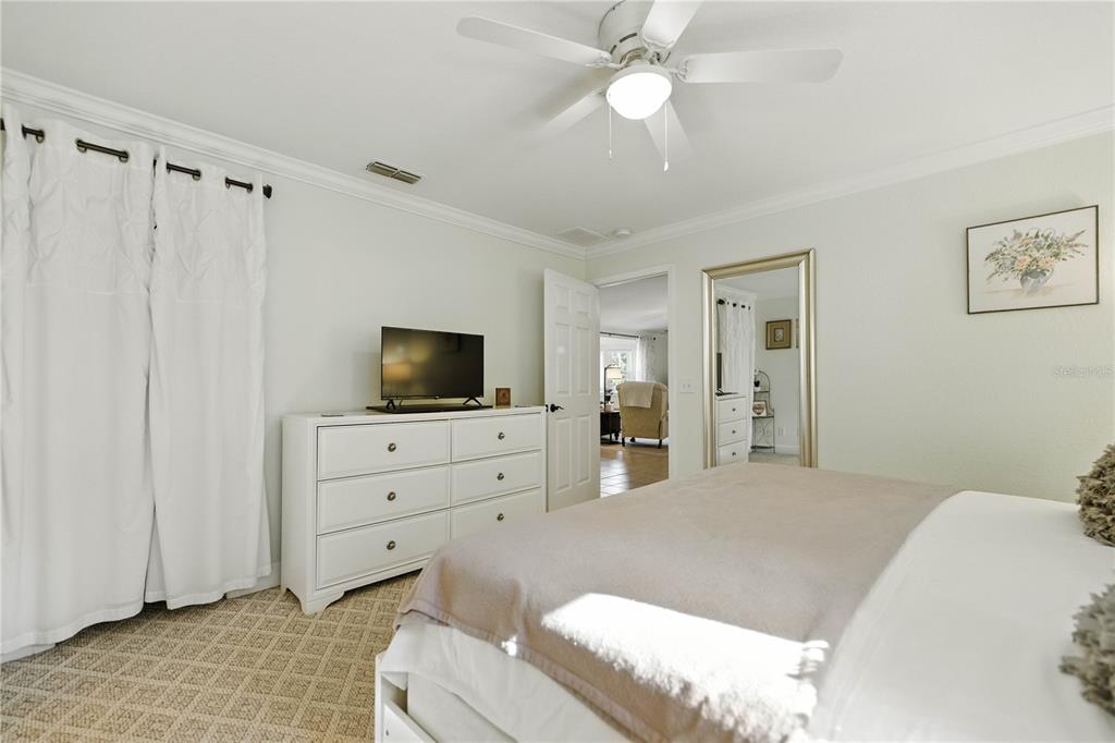5968 Southwest 103rd Loop Ocala, FL 34476 - Photo 12 of 48 a bedroom with a bed a flat screen tv and dresser