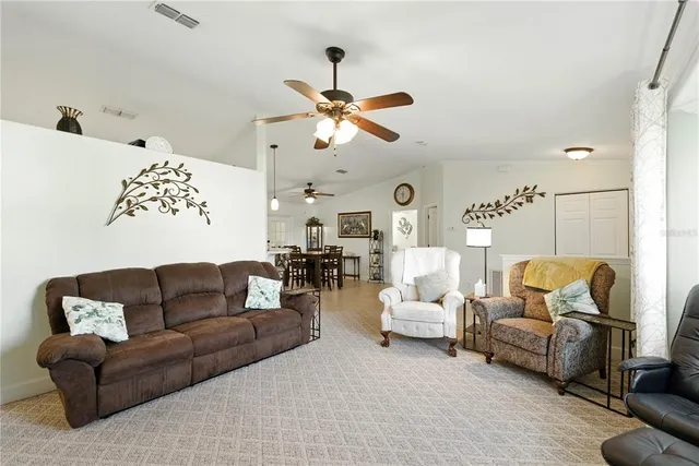 a living room with furniture ceiling fan and a rug