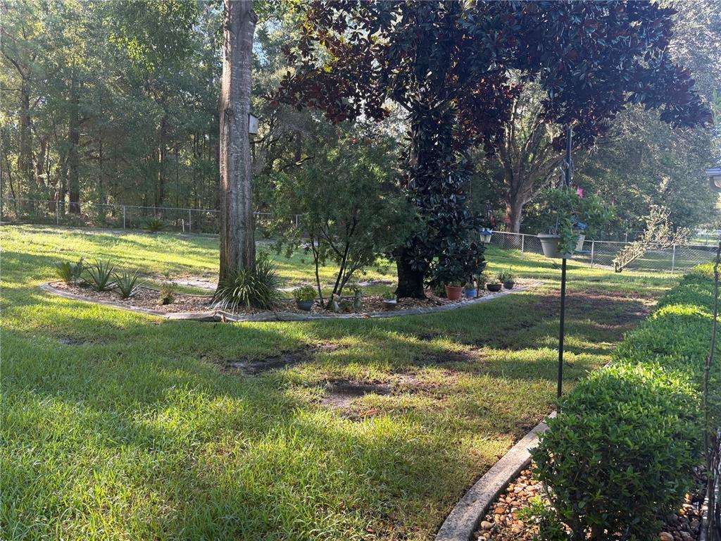 5968 Southwest 103rd Loop Ocala, FL 34476 - Photo 25 of 48 a view of a house with a backyard