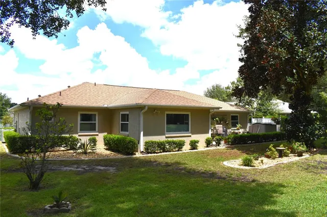 a view of a house with a yard patio and fire pit