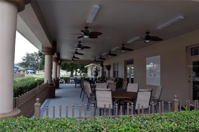 a view of a porch with chairs and backyard