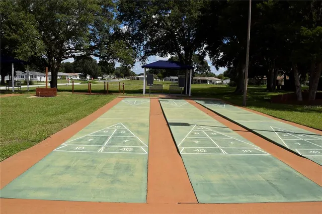 a patio with a table and chairs under an umbrella