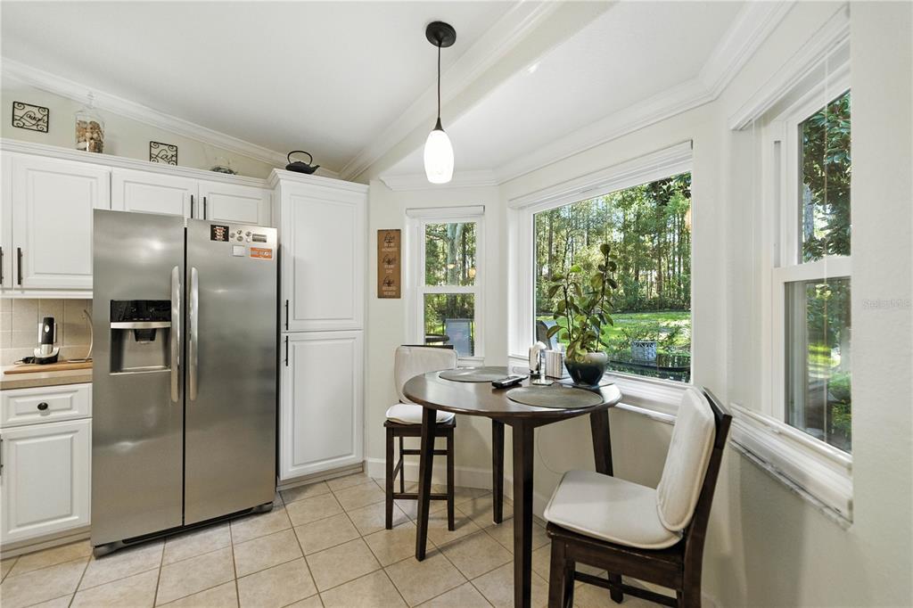 5968 Southwest 103rd Loop Ocala, FL 34476 - Photo 6 of 48 a dining room with furniture a chandelier and window