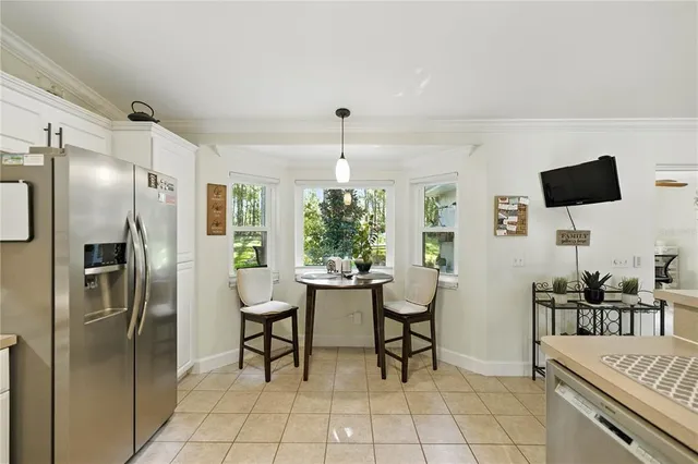 a kitchen with stainless steel appliances kitchen island granite countertop a refrigerator and a stove top oven