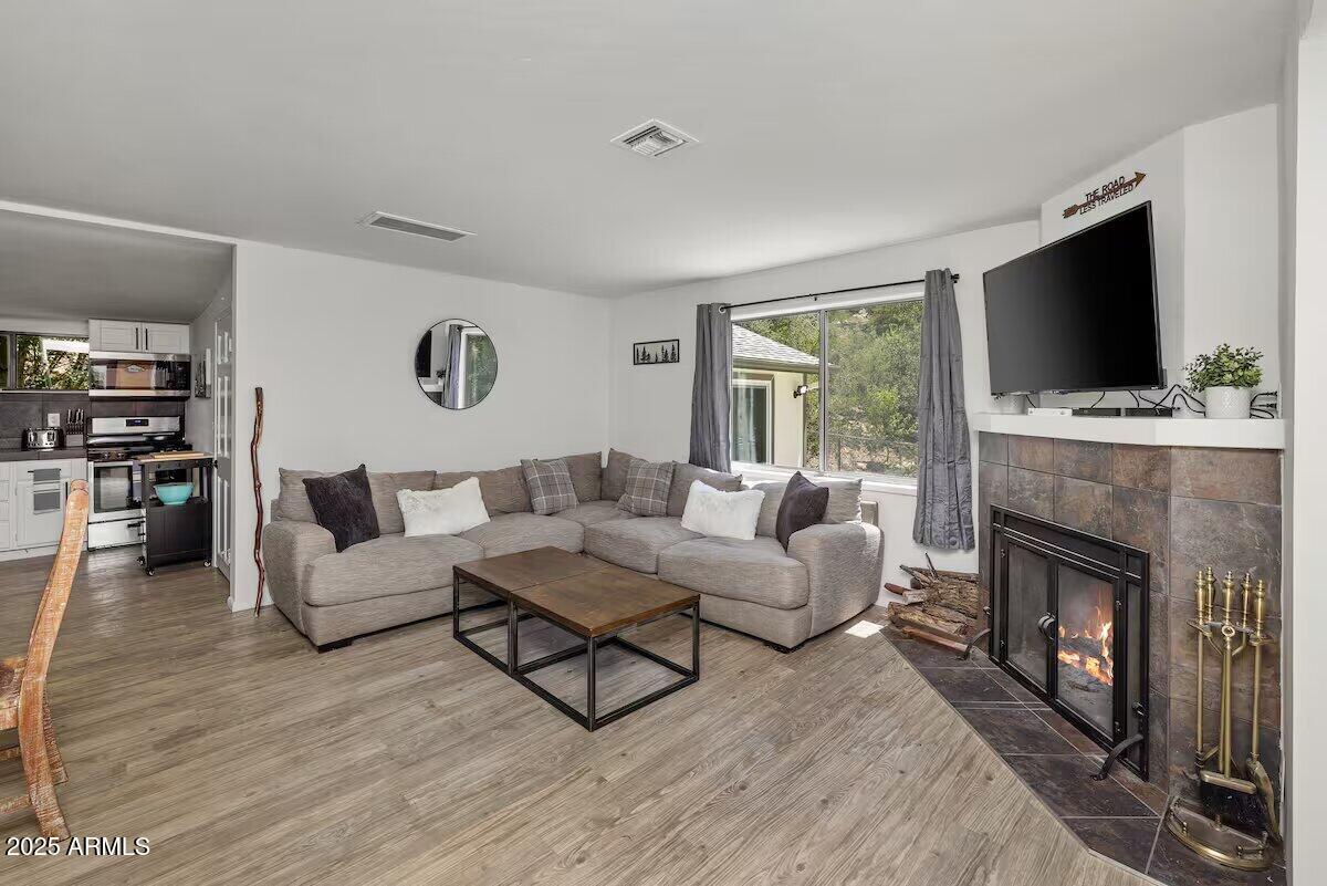 a living room with furniture a flat screen tv and a fireplace