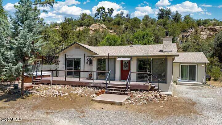 1822 Idylwild Road Prescott, AZ 86305 - Photo 2 of 25 a view of a white house with large windows and a table and chairs