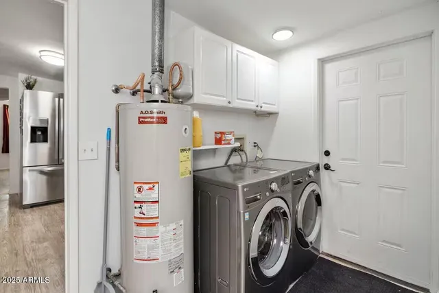 a view of washer and dryer with kitchen in the background
