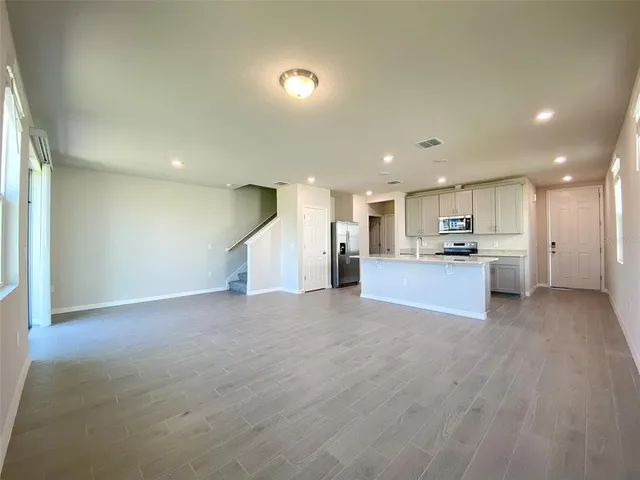 a view of a kitchen with a sink and cabinets