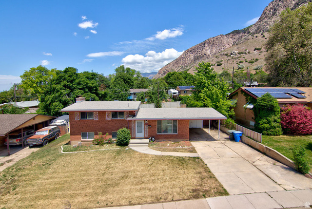 1272 Cook Street Ogden, UT 84404 - Photo 1 of 46 Brick exterior with a covered carport and an additional covered parking structure